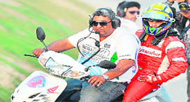 Ferrari driver Felipe Massa rides a scooter back to pit after crashing-out of the race on Sunday. 
