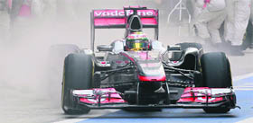 McLaren-Mercedes driver Lewis Hamilton steers his car from the pit during Indian GP at the Buddh International circuit in Greater Noida on Sunday.