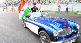 Red Bull Formula One driver Mark Webber sits in a car during the drivers' parade before the Formula One Grand Prix at the Buddh International Circuit in Greater Noida on Sunday.
