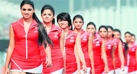 Grand Prix grid girls walk on the track during the drivers' parade on Sunday.