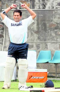 Sachin Tendulkar stretches during a net session at the Ferozeshah Kotla stadium in New Delhi on Friday