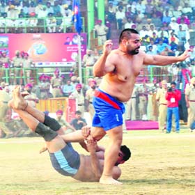 An Indian player grabs an Australian raider during the Kabaddi World Cup in Sangrur on Sunday