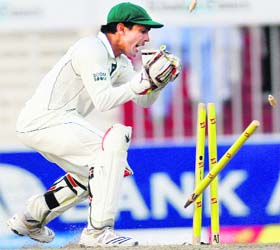 Pakistan's Adnan Akmal attempts to run out Sri Lanka's Kosala Kulasekara during the fourth day of their third Test in Sharjah on Sunday