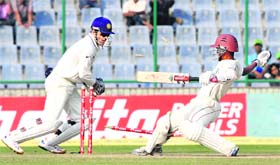 MS Dhoni stumps West Indian batsman Kraigg Brathwaite off the bowling of Pragyan Ojha in New Delhi on Sunday