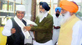 Chief Minister Parkash Singh Badal honours retired DGP Izhar Alam with a siropa in Malerkotla.