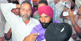 Workers walk out of a meeting of the Lok Bhalai Party in Jalandhar. 