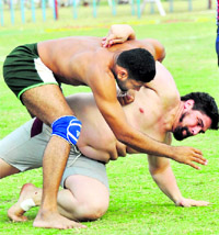 Pakistan (L) and Argentina players battle it out during their match in Kapurthala on Wednesday