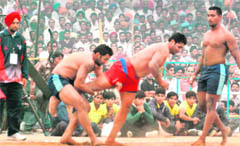 Kabaddi players of India (blue) and Canada (red) in action in Muktsar 