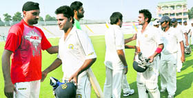 Punjab captain Harbhajan Singh (L) pats Ravi Inder Singh after they defeated Orissa at the PCA Stadium in Mohali on Saturday.