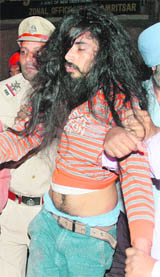 A SAD (A) activist being taken away for raising slogans during Advani�s yatra in Amritsar.