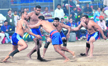 An Indian raider (L) vies with a stopper from Italy during their Kabaddi World Cup match in Bathinda on Friday.