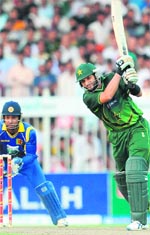 Pakistan's Shahid Afridi (R) bats as Sri Lanka�s Kumar Sangakkara looks on during the fourth ODI match in Sharjah on Sunday