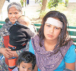 Sonia, wife of deceased prisoner Baldev Singh, with her children outside the Kapurthala Civil Hospital mortuary on Monday. A Tribune photograph
