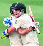 Australia's Mitchell Johnson and Patrick Cummins celebrate after winning the second and final Test against South Africa in Johannesburg