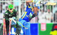 Sri Lanka's Kumar Sangakkara (R) gets dismissed by Pakistan's Shahid Afridi (unseen) as wicketkeeper Sarfraz Ahmed looks on during their fourth ODI match in Sharjah