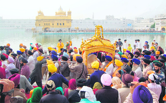 Devotees take out a procession on the eve of the martyrdom day of Guru Teg Bahadur at the Golden Temple in Amritsar on Wednesday.