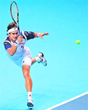 David Ferrer of Spain returns against Novak Djokovic of Serbia during their singles match in the ATP World Tour Finals in London on Wednesday. Ferrer won 6-3, 6-1. 