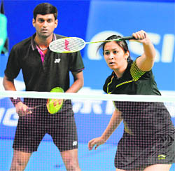 V Diju (L) and Jwala Gutta play Joachim Fischer Nielsen and Christinna Pedersen of Denmark in the mixed doubles at the China Open in Shanghai on Thursday.