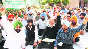 Members of the Rural Development and Panchayat Officers Association stage a dharna outside Vikas Bhavan,  headquarters of the Rural Development and Panchayat Department, in Mohali on Friday. 