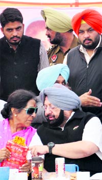 Punjab Pradesh Congress Committee chief Capt Amarinder Singh shares a point with Member of Parliament Santosh Chaudhary as other Congress leaders look on at a rally in Mahilpur on Sunday