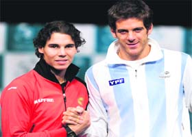 Rafael Nadal (L) of Spain shakes hand with Juan Martin Del Potro of Argentina during the David Cup final draw in Seville on Thursday