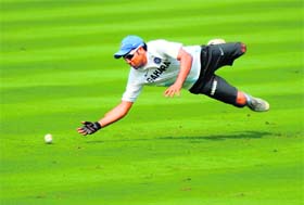 Rohit Sharma dives to stop a ball during a training session ahead of the second ODI against West Indies in Visakhapatnam on Thursday