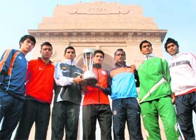 Captains of the teams playing in the South Asian Football Federation Championship pose with the trophy in front of India Gate in New Delhi on Thursday