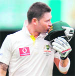 Australia�s captain Michael Clarke kisses his helmet after scoring a century against New Zealand in the Test match in Brisbane 