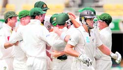 New Zealand�s Ross Taylor (R) walks back after being dismissed by Australia�s James Pattinson in Brisbane on Sunday