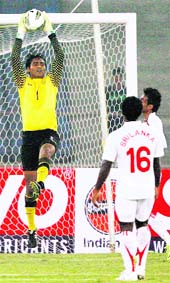 Indian goalkeeper Karanjit Singh jumps to save a goal against Sri Lanka in New Delhi on Wednesday