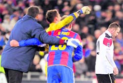Manchester United's Wayne Rooney (R) leaves as FC Basel players celebrate their qualification at the end of the UEFA Champions League match in Basel on Thursday. Basel won 2-1 and Manchester United did not qualify for Champions League