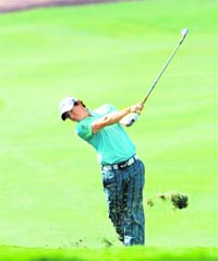 Rory McIlroy plays a shot during the first round of the European Tour's Dubai World Golf Championship on Thursday