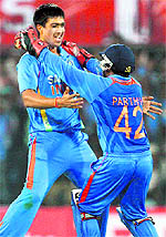 Rahul Sharma (L) celebrates a wicket against the