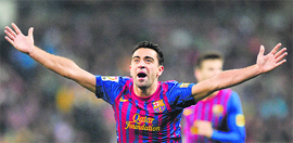 Barcelona's Xavi Hernandez celebrates during the "El clasico" Spanish League match against Real Madrid in Madrid on Saturday. Barcelona won 3-1.