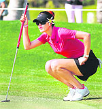 Michelle Wie of US lines a putt during the final round of the Dubai Ladies Masters golf tournament in Dubai on Saturday. The event was won by Alexis Thompson of the US
