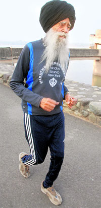 100-year-old world famous marathon runner Fauja Singh jogs at the Sukhna Lake in Chandigarh on Saturday