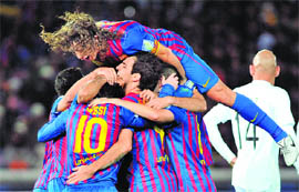 Barcelona players celebrate Cesc Fabregas' goal against FC Santos during their FIFA Club World Cup final in Yokohama on Sunday. Barcelona won 4-0.