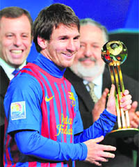 File picture of Lionel Messi holding the Gold Ball trophy after the final of FIFA Club World Cup. Messi was elected "Champion of the Champions 2011" by French daily sports newspaper L'Equipe on Saturday. 