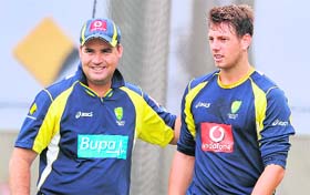 Australian coach Micky Arthur (L) gives paceman James Pattinson (R) a pat on the back during training in Melbourne ahead of the first Test