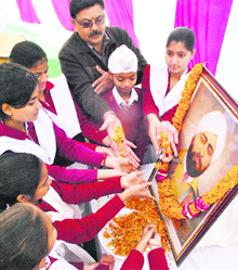Schoolchildren pay floral tributes to Shaheed Udham Singh on his 112th birth anniversary in Patiala on Monday. 