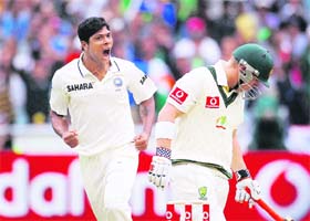 Umesh Yadav (L) celebrates the wicket of David Warner (R) in Melbourne on Monday