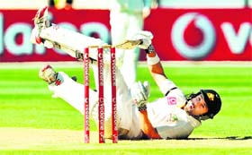 Ed Cowan falls to the ground to avoid a delivery from Zaheer Khan in Melbourne on Monday