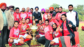 Players from Punjab Police pose with the winners trophy after winning the All-India Liberals Hockey title in Nabha on Friday. Punjab Polce defeated EME Jalandhar in the final.