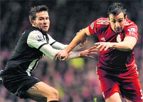 Liverpool's Jose Enrique (R) vies with Newcastle United's Yohan Cabaye on Friday