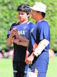 Sachin Tendulkar talks with his son, Arjun during a team training session in Sydney on Sunday