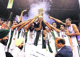 Punjab team players celebrate with their trophy after winning the National Basketball Championship
