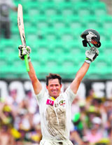 Ricky Ponting raises his bat after completing his century in Sydney on Wednesday. 