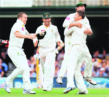 Mike Hussey leaps into the arms of Australian captain Michael Clarke (R) after catching Sachin Tendulkar at first slip, as Peter Siddle (L) and Ricky Ponting join in the celebrations in Sydney on Friday. Australia won the match by an innings and 68 runs and lead the 4-match series 2-0. 