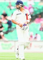 Virat Kohli walks back after being dismissed by James Pattinson in Sydney on Friday. 