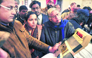 An election official demonstrates the functioning of an electronic voting machine for government employees who would be deployed on poll duty, in Jalandhar on Sunday